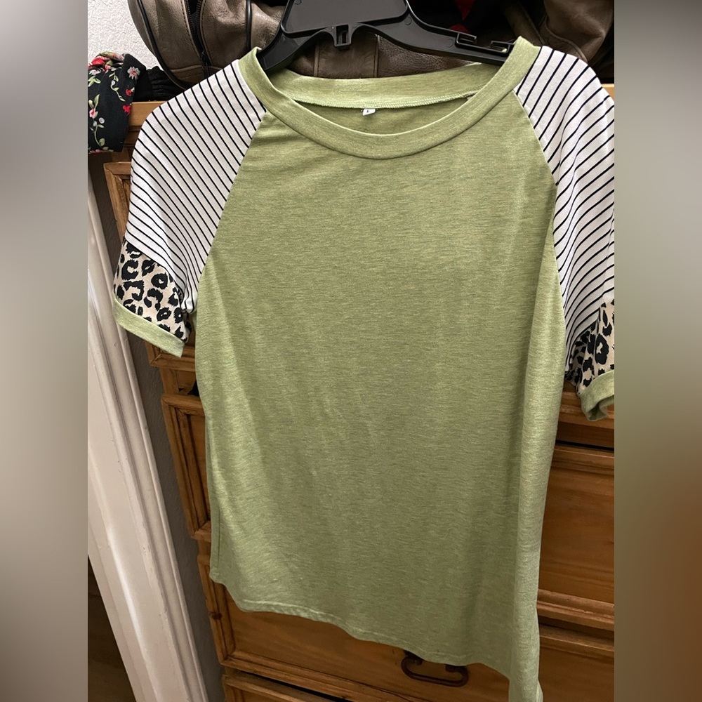 Green crewneck top with patterned sleeves